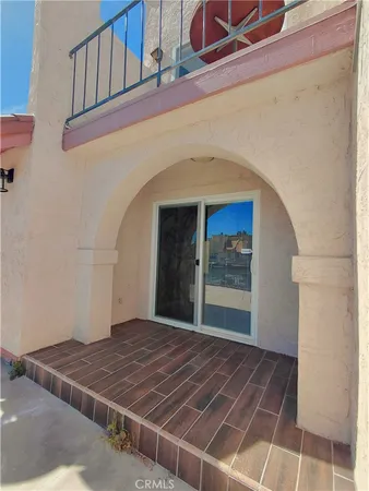 a view of a blue house with a yard and plants