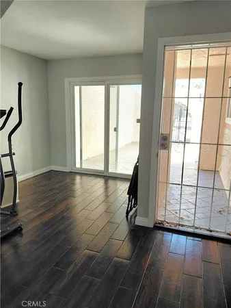 a view of a room with wooden floor and windows