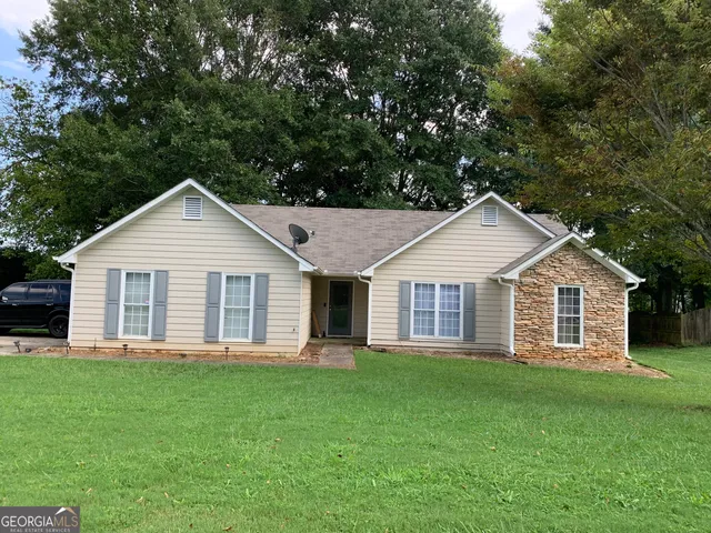 a front view of house with yard and green space