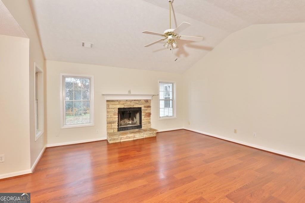 154 Leighs Grove Court Grayson, GA 30017 - Photo 5 of 11 an empty room with windows fireplace and a sink