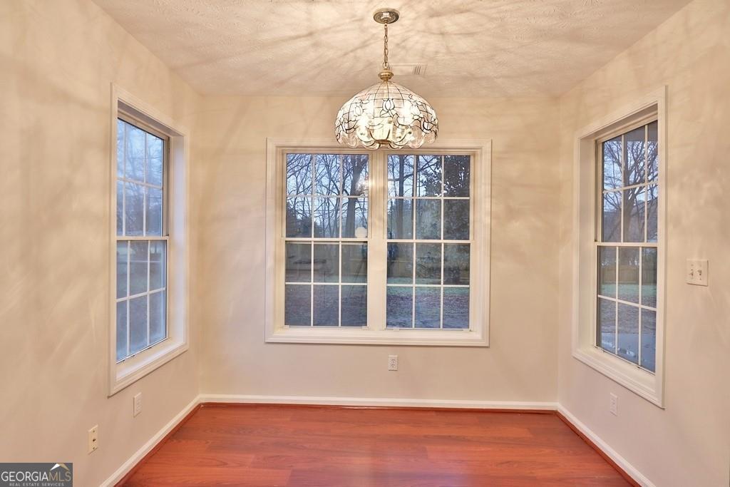 154 Leighs Grove Court Grayson, GA 30017 - Photo 8 of 11 a view of an empty room with wooden floor and windows