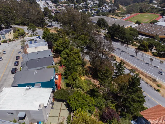 an aerial view of residential houses with outdoor space