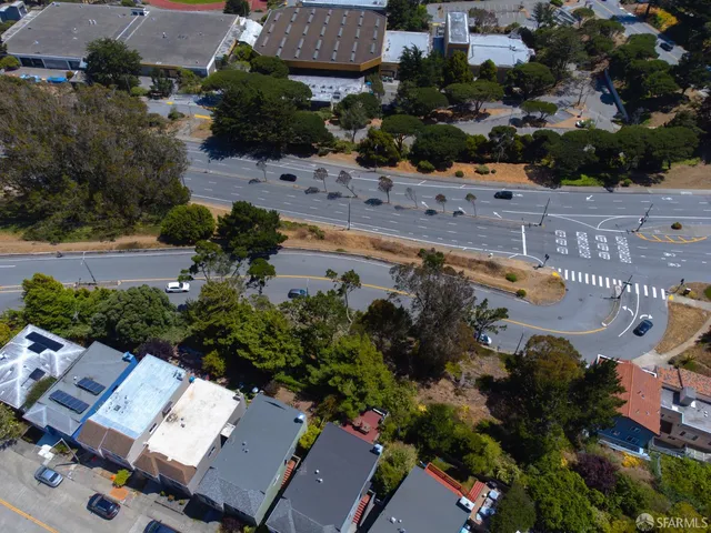 an aerial view of a house with a yard