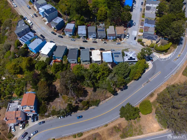 an aerial view of a house with a yard and garden