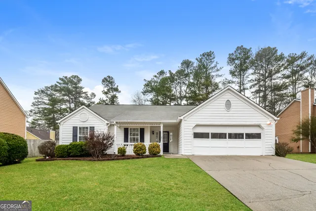 a front view of a house with a garden and porch
