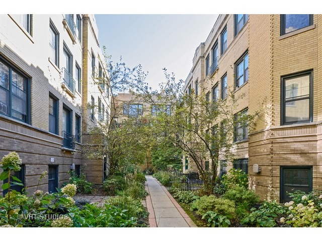 7031.5 North Sheridan Road, Unit 1N Chicago, IL 60626 - Photo 1 of 8 a view of a residential apartment building with a yard