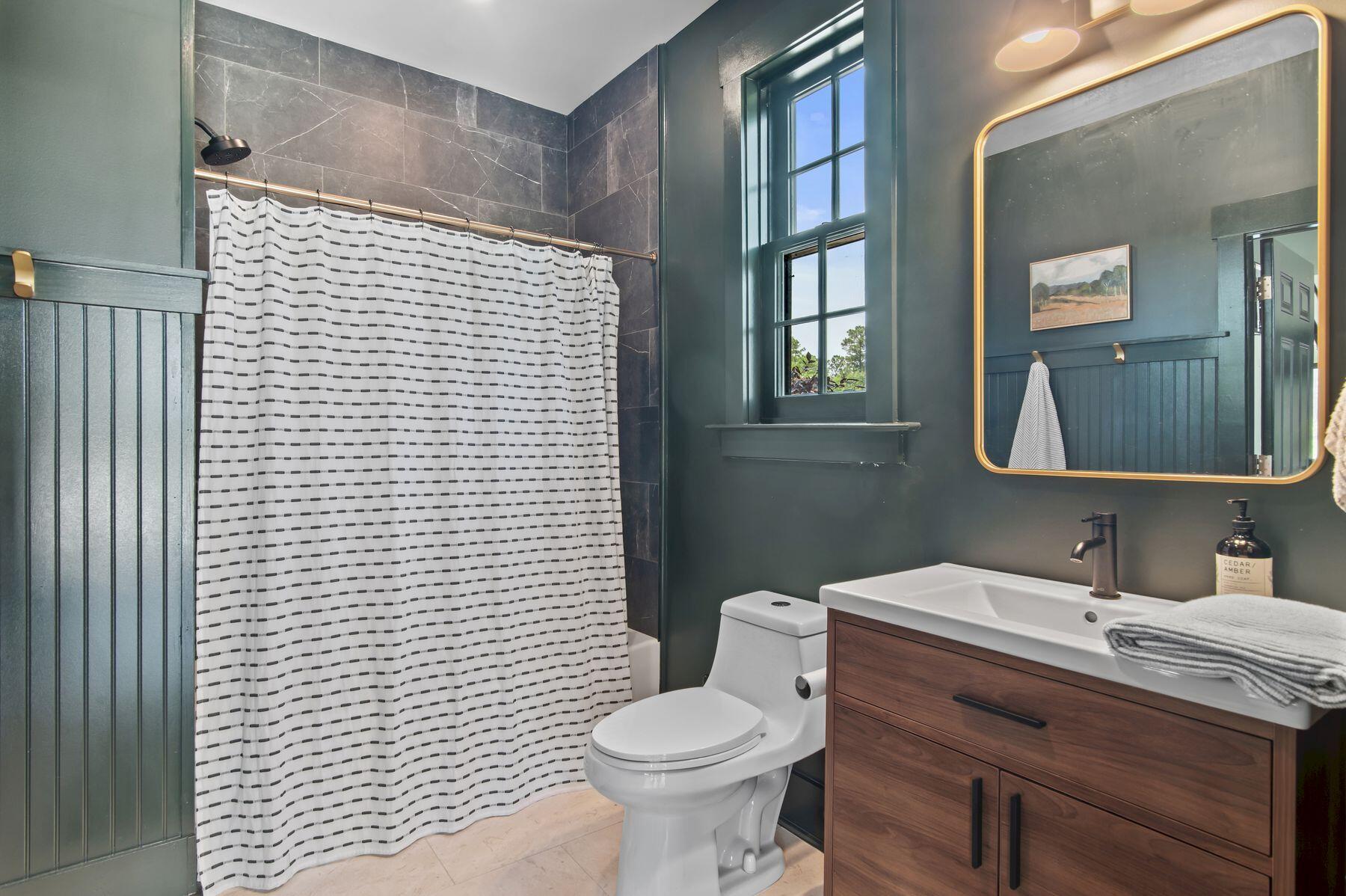 181 Jonathan Drive Freeport, FL 32439 - Photo 55 of 59 a bathroom with a toilet sink vanity and mirror