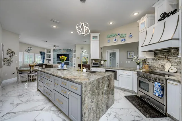 a kitchen with granite countertop a refrigerator and a stove