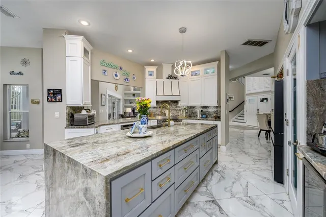 a kitchen with stainless steel appliances granite countertop a stove and a sink