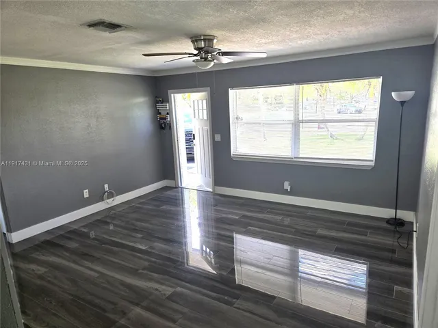 a view of wooden floor and windows in a room