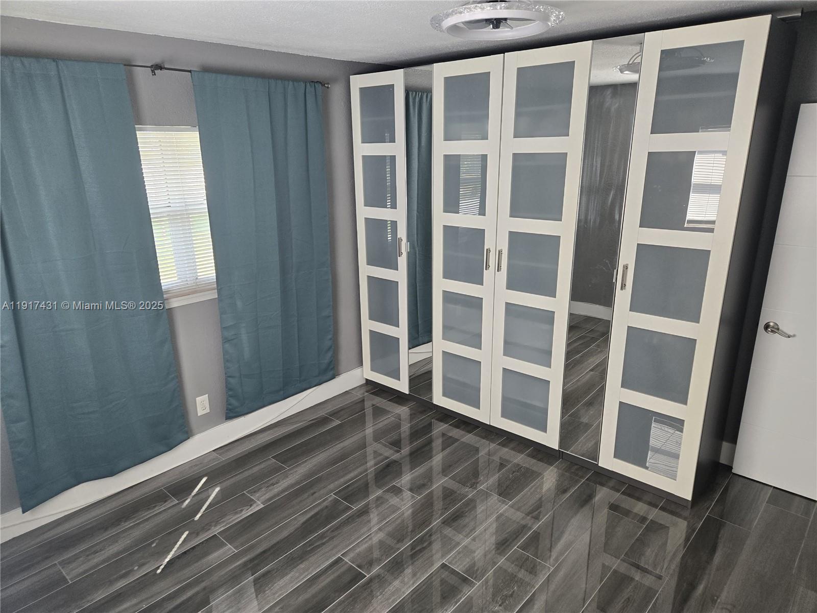 2190 Northeast 1st Lane Boynton Beach, FL 33435 - Photo 6 of 14 a view of an empty room with wooden floor and a window