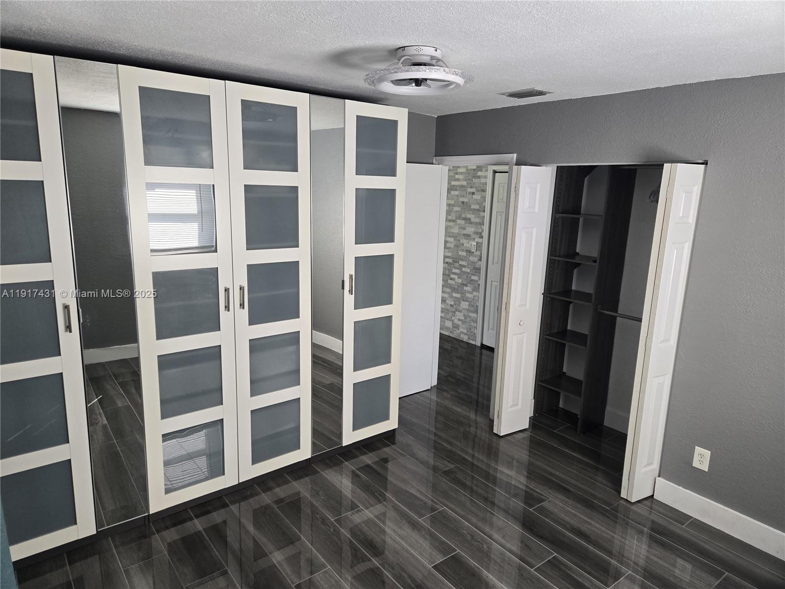 2190 Northeast 1st Lane Boynton Beach, FL 33435 - Photo 7 of 14 a view of an empty room with wooden floor and a window