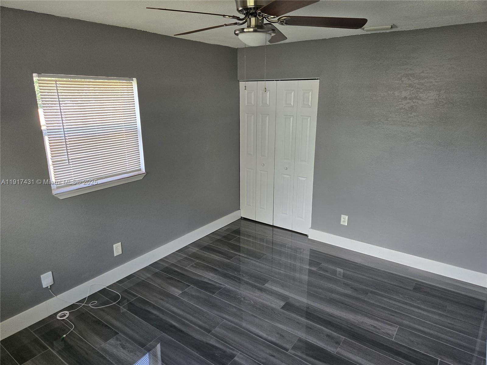 2190 Northeast 1st Lane Boynton Beach, FL 33435 - Photo 8 of 14 a view of an empty room with wooden floor and a window