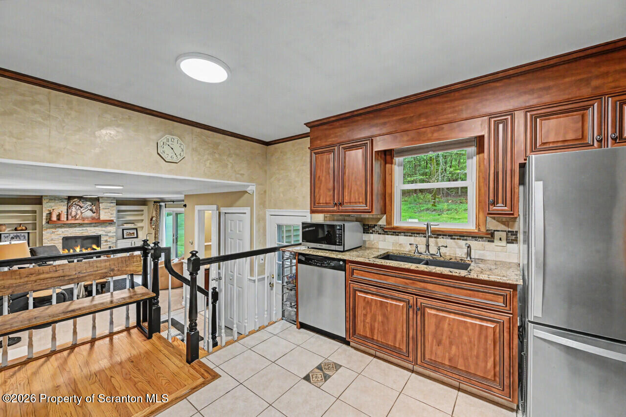 121 T Rt 351 Moscow, PA 18444 - Photo 29 of 79 a kitchen with stainless steel appliances granite countertop a refrigerator and a sink