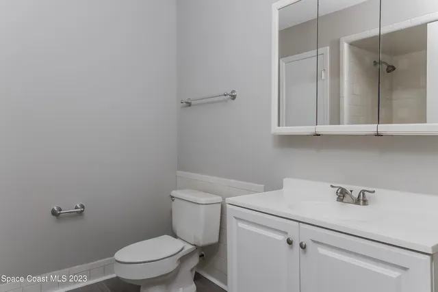 a bathroom with a sink a toilet and vanity