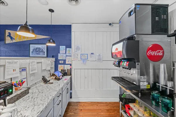 a outdoor space with lots of tables a large window and chairs