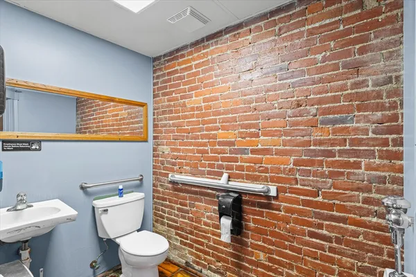 an empty room with a window and a ceiling fan