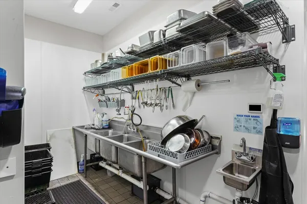 a kitchen with granite countertop a refrigerator stove and sink