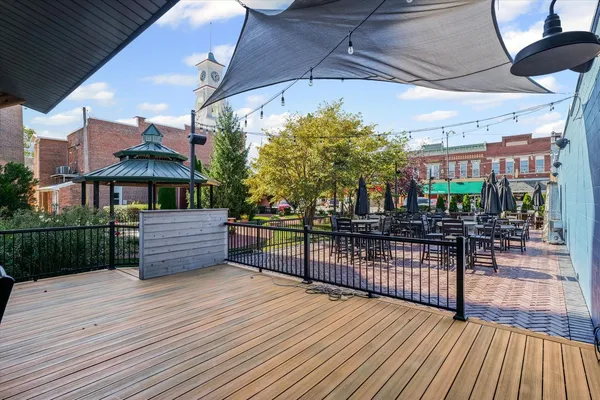 an empty room with wooden floor and ceiling fan