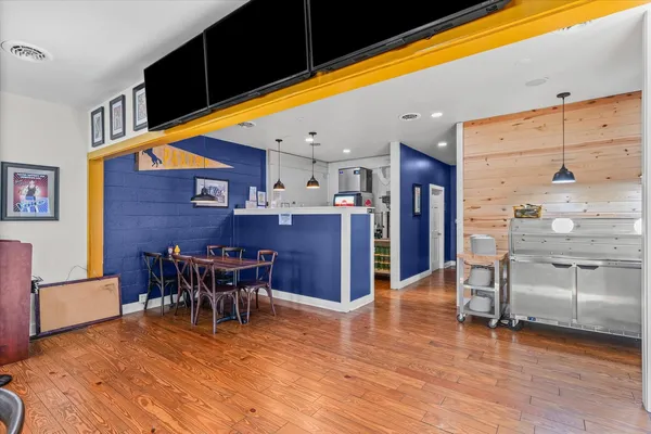 a view of a dining room with furniture wooden floor and chandelier