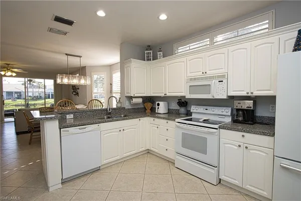 a kitchen with stainless steel appliances granite countertop a sink and cabinets