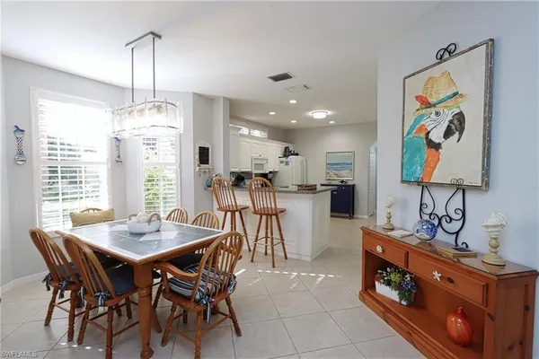 a view of a dining room with furniture and a chandelier