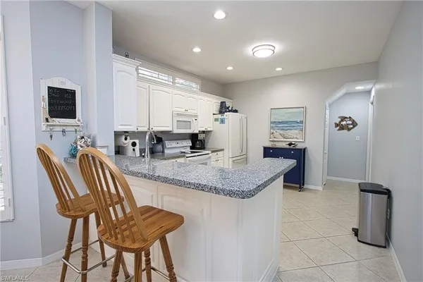 a kitchen with granite countertop sink and cabinets