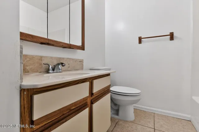 a bathroom with a sink a toilet and mirror