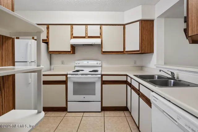 a kitchen with a sink stove and cabinets