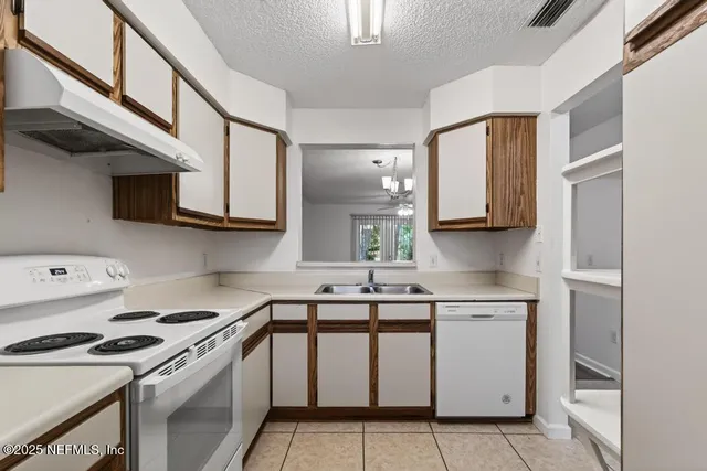 a kitchen with stainless steel appliances granite countertop a sink and a stove