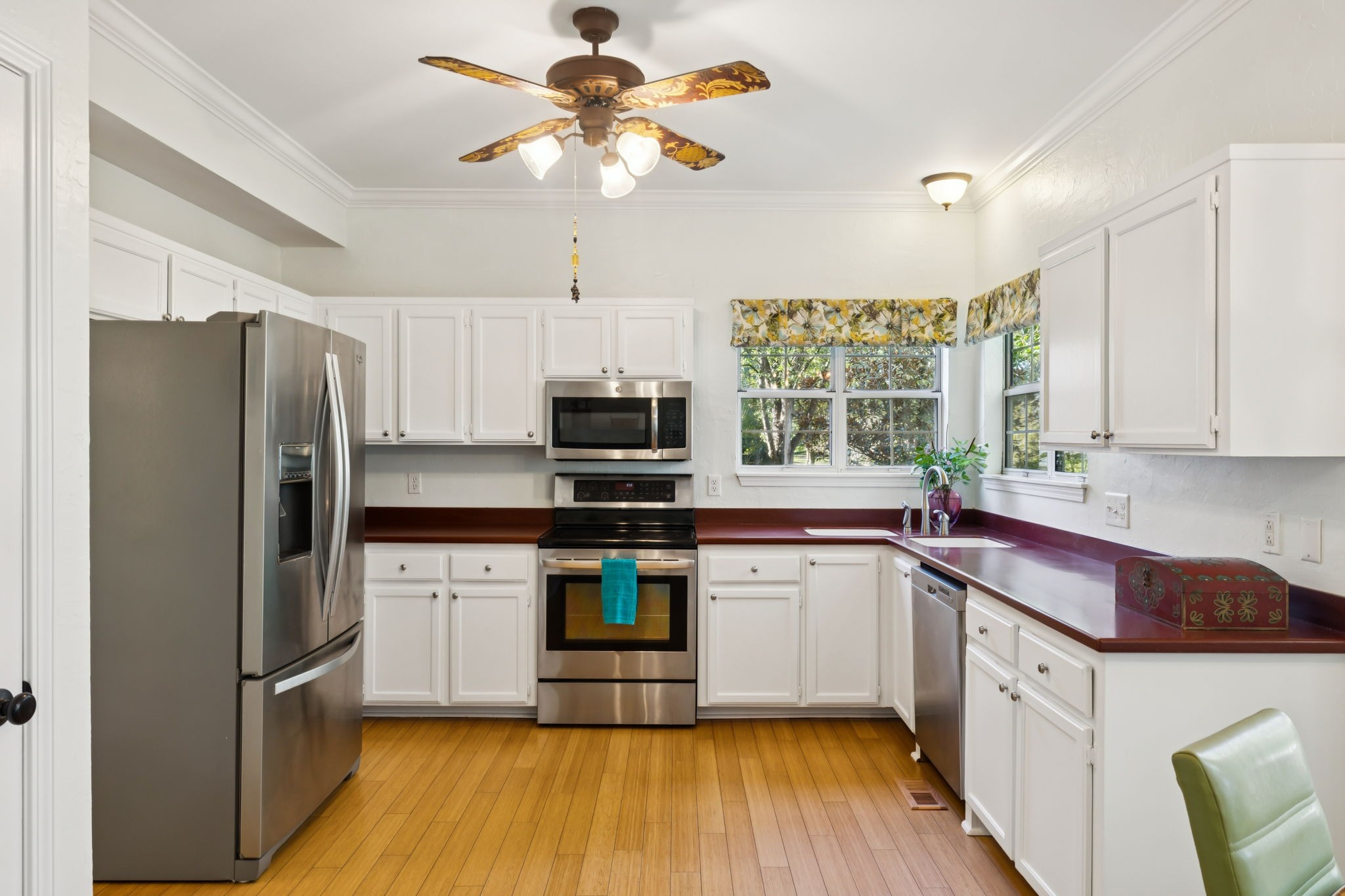 148 Cavalcade Circle Franklin, TN 37069 - Photo 16 of 43 a kitchen with stainless steel appliances a refrigerator a sink dishwasher a stove and white cabinets with wooden floor
