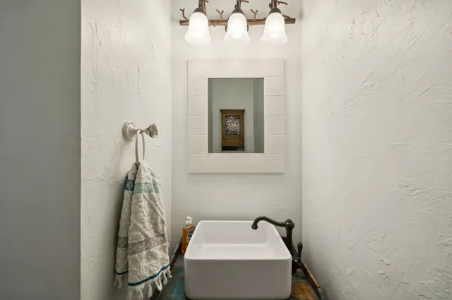 a bathroom with a sink and mirror