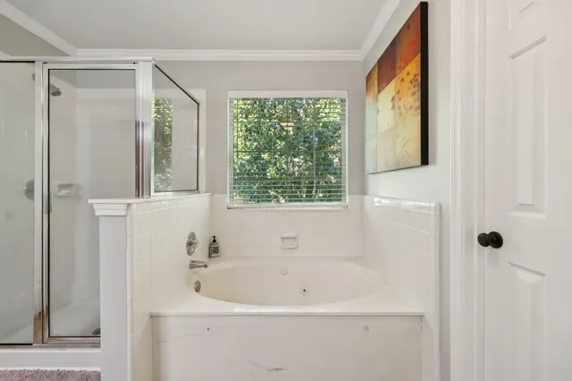 a white bath tub sitting next to a window