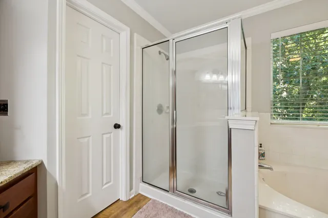 a bathroom with a glass shower door