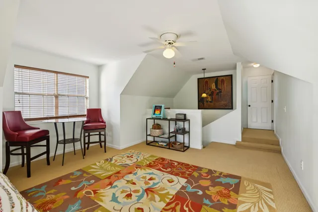 a bed room with a bed and a chair