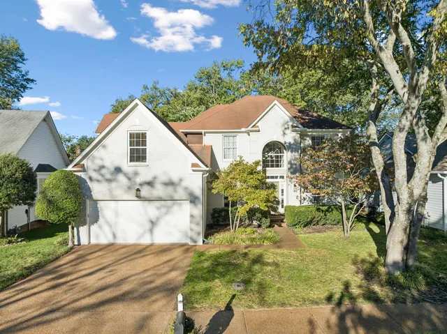 a view of a white house with a yard