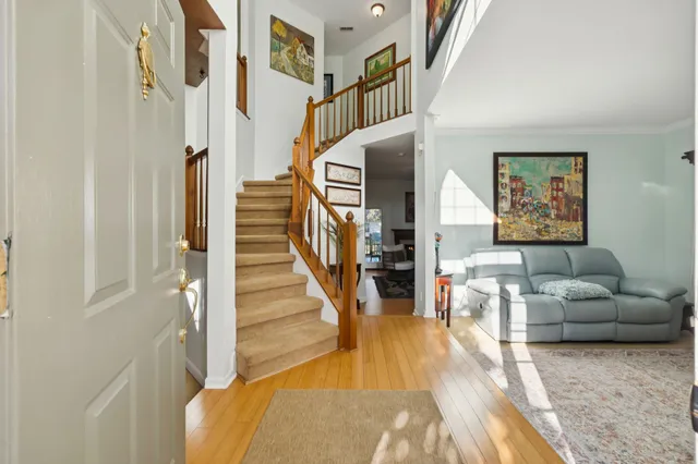 a living room with fireplace furniture and a wooden floor