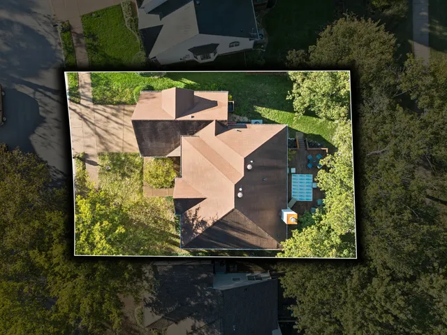 an aerial view of a house with a yard