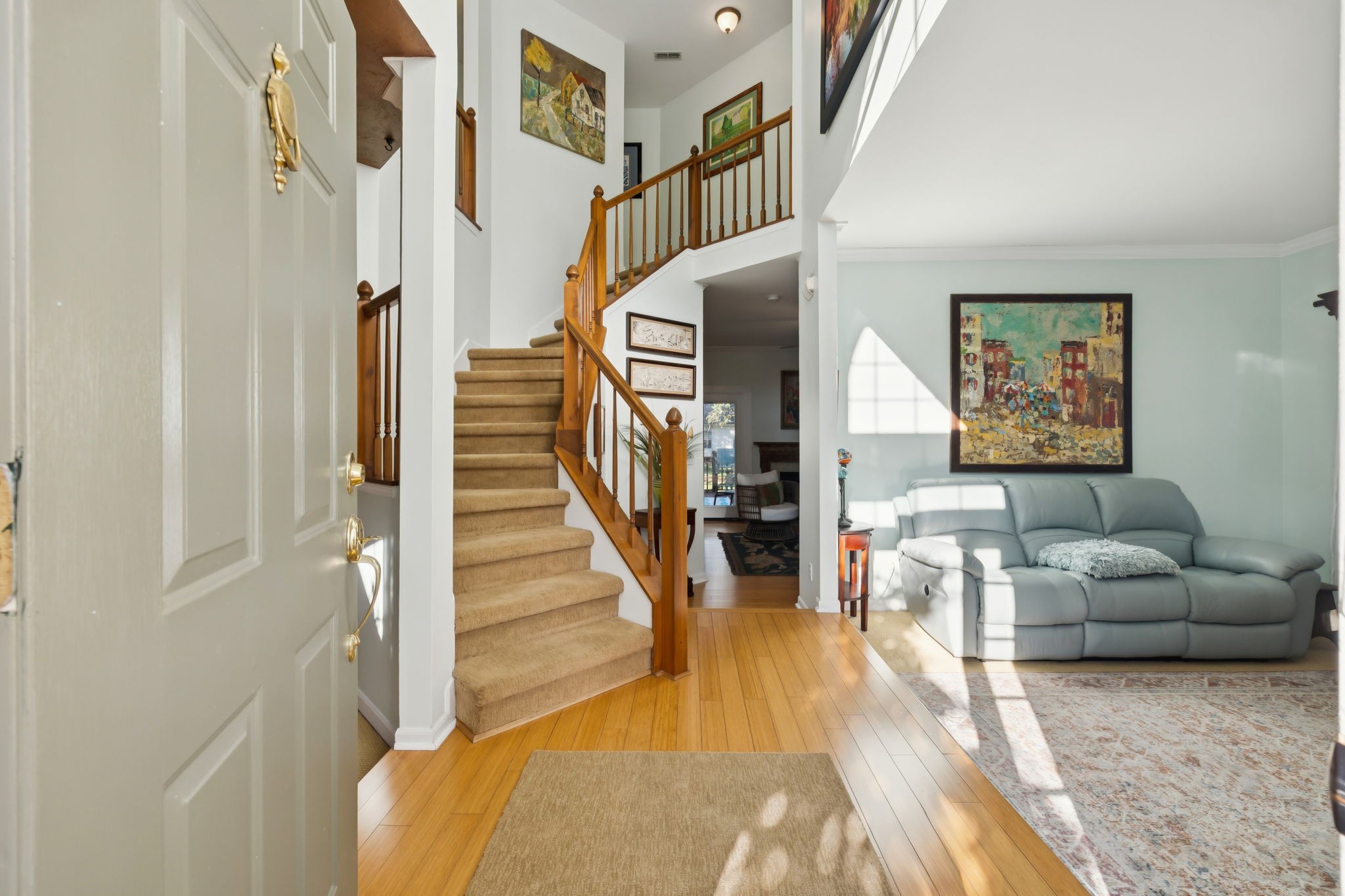 148 Cavalcade Circle Franklin, TN 37069 - Photo 5 of 43 a living room with couches and paintings on the wall with wooden floor