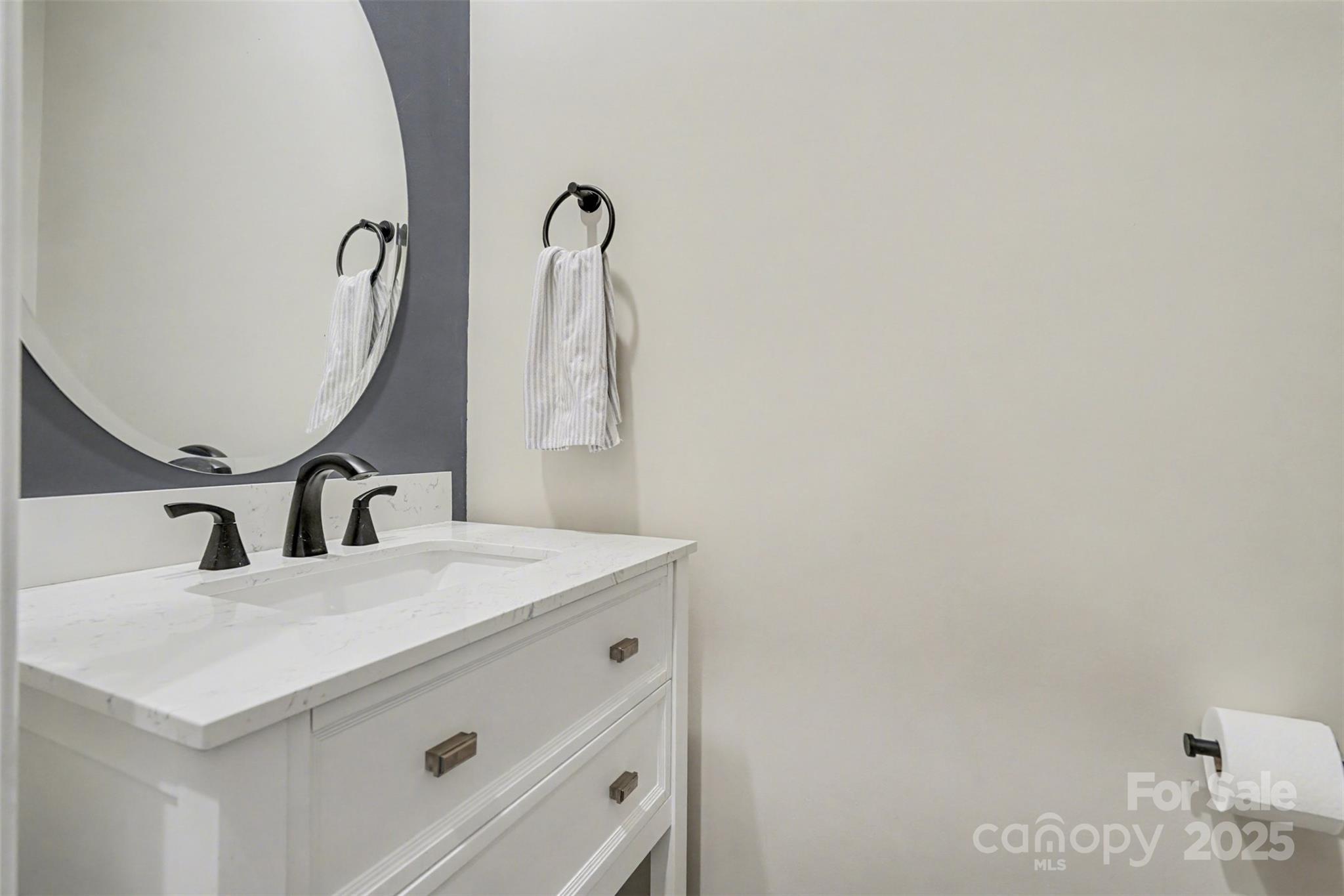 6220 Hailstone Road Charlotte, NC 28215 - Photo 12 of 37 a bathroom with a sink and a mirror