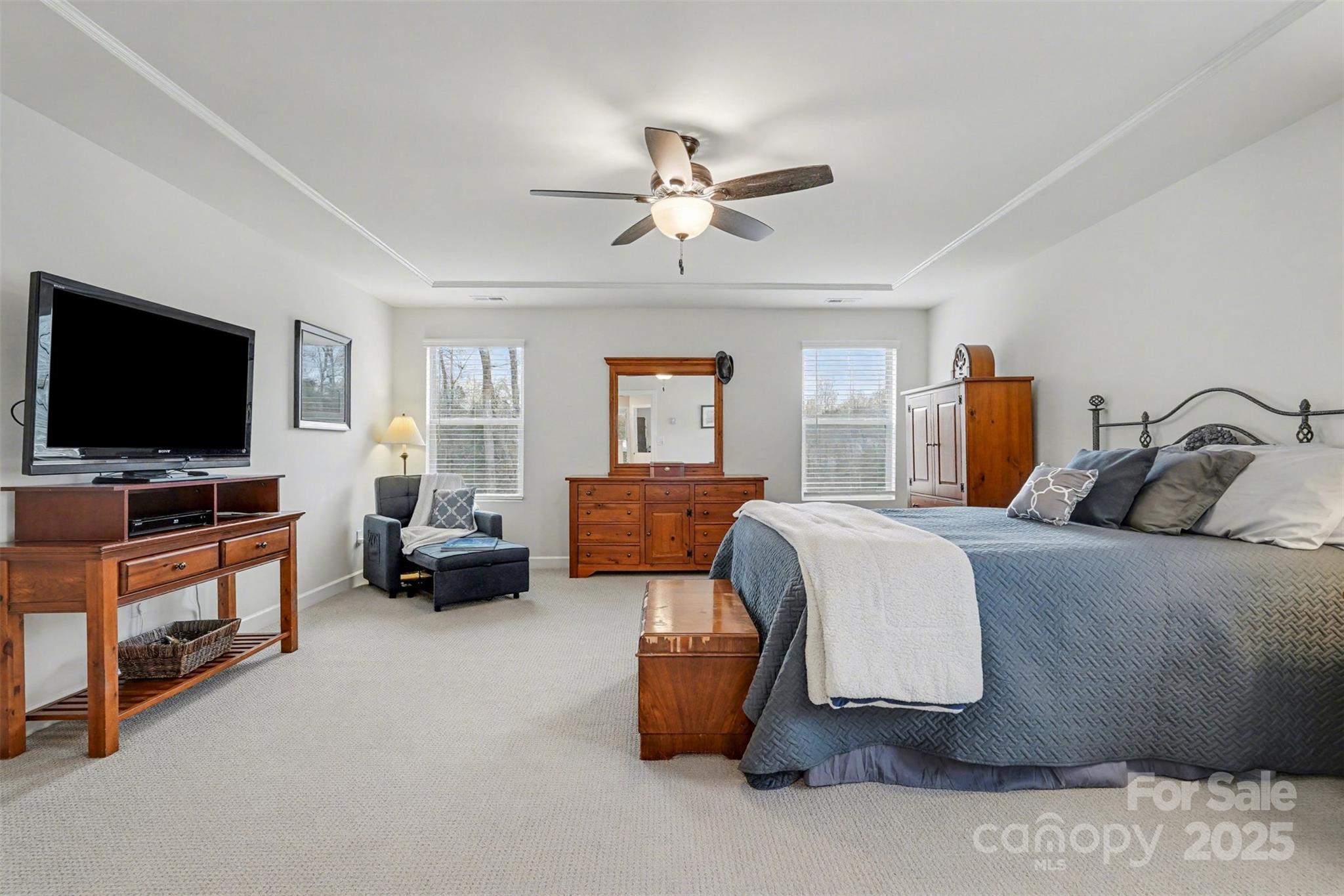 6220 Hailstone Road Charlotte, NC 28215 - Photo 18 of 37 a bedroom with a bed and flat screen tv