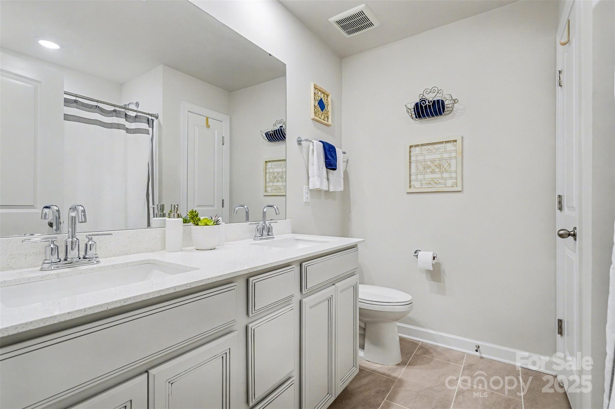 6220 Hailstone Road Charlotte, NC 28215 - Photo 23 of 37 a bathroom with a granite countertop sink a toilet and a mirror