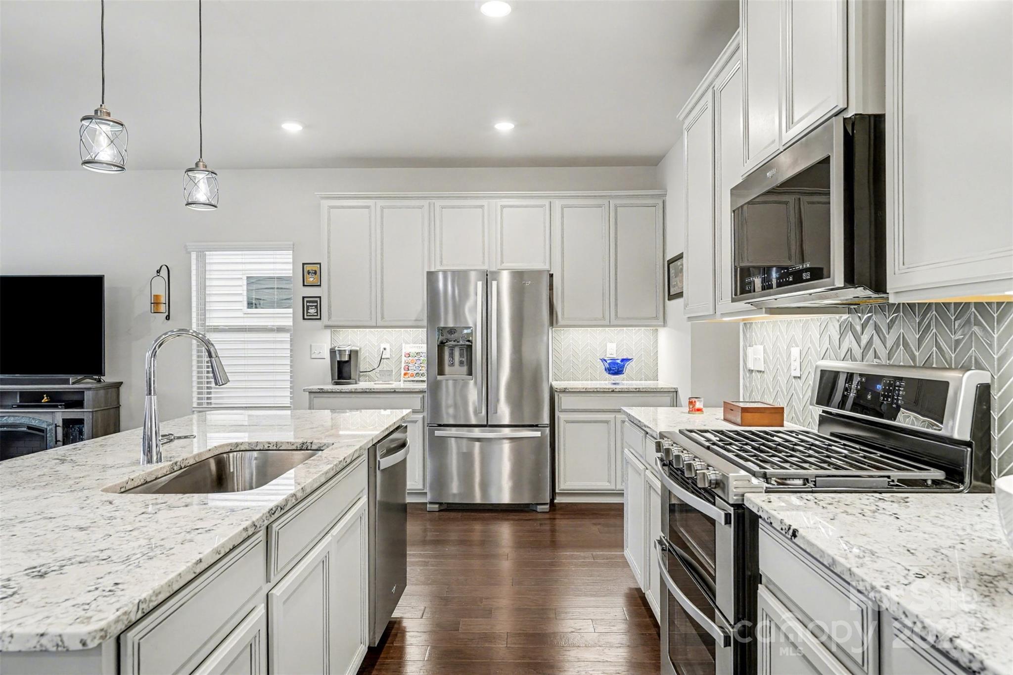 6220 Hailstone Road Charlotte, NC 28215 - Photo 9 of 37 a kitchen with a stove a sink and a refrigerator