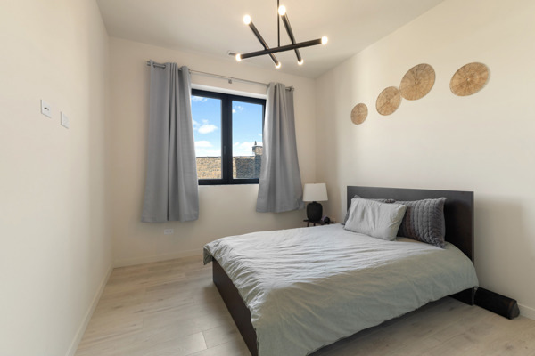 2135 West Cermak Road, Unit 3S Chicago, IL 60608 - Photo 9 of 14 a bedroom with a bed and a mirror