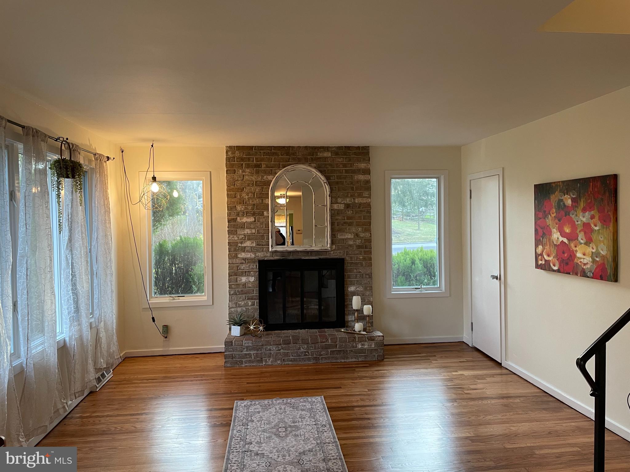 2400 Edge Hill Road Willow Grove, PA 19090 - Photo 14 of 43 an empty room with wooden floor fireplace and windows
