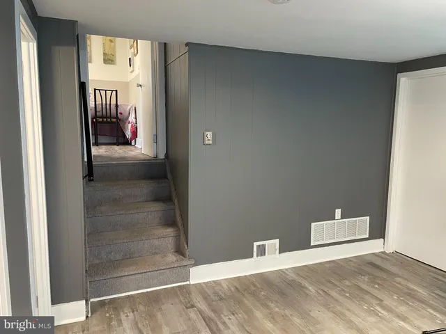 a bedroom with a bed and a lamp