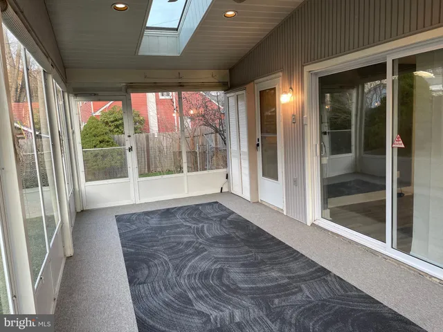 a view of room with window and front door