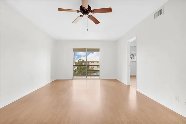 a view of empty room with a fan