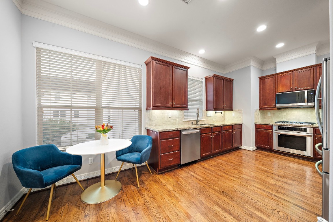 3929 Floyd Street Houston, TX 77007 - Photo 2 of 42 Sunlit breakfast nook offers an inviting corner for morning coffee or casual meals, framed by expansive windows and gleaming hardwood floors.