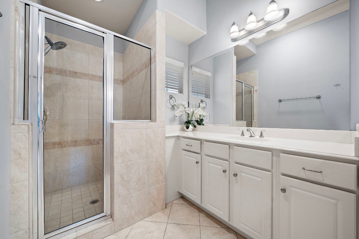 3929 Floyd Street Houston, TX 77007 - Photo 27 of 42 Bright primary bath features a spacious glass-enclosed walk-in shower, a large double vanity with crisp white cabinetry, and elegant tile floors.